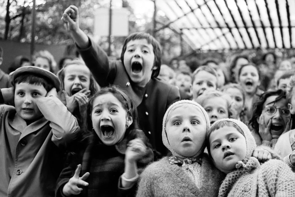 Children watching a puppet show in 1963